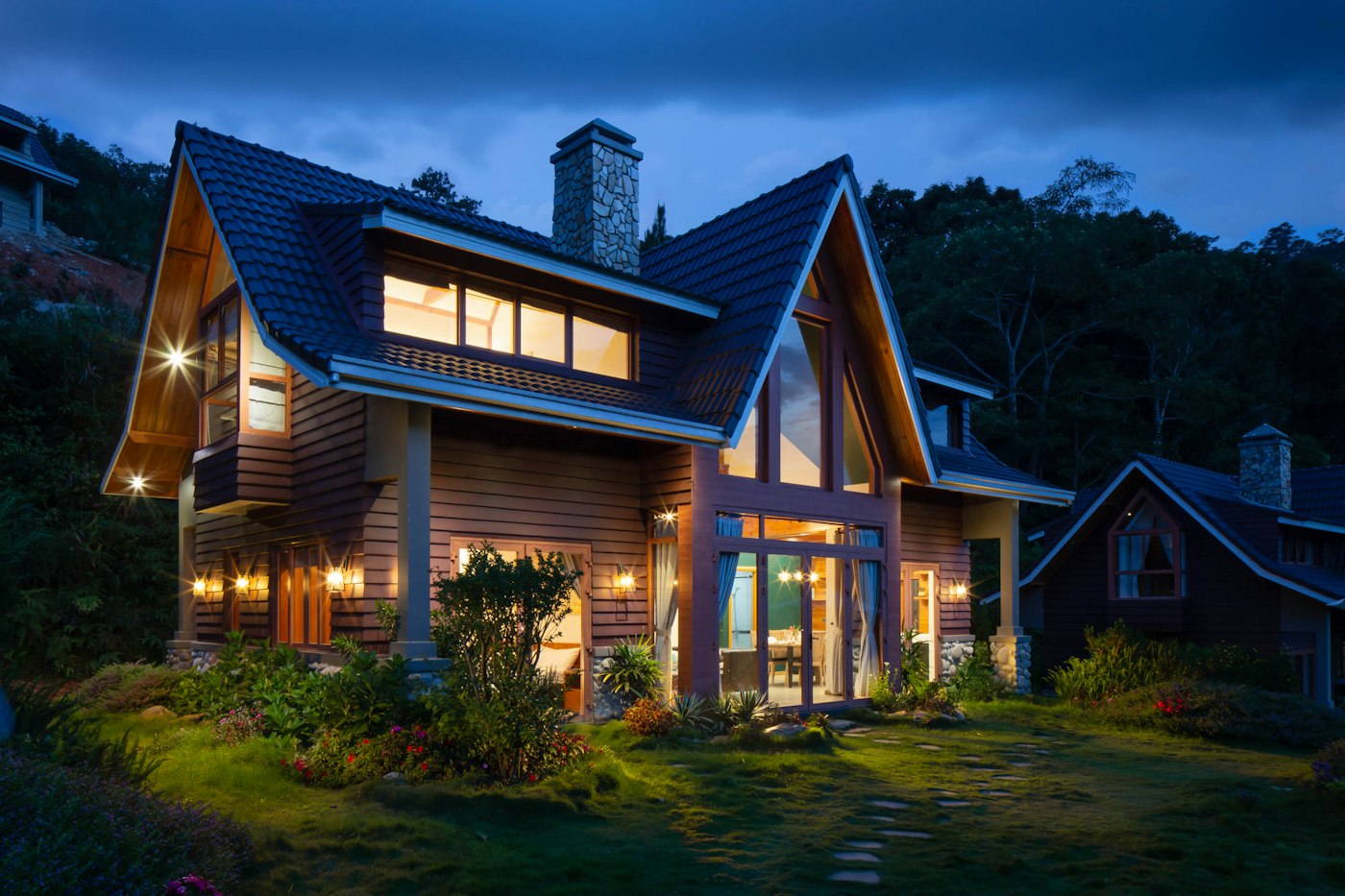 An architectural home lit at dusk